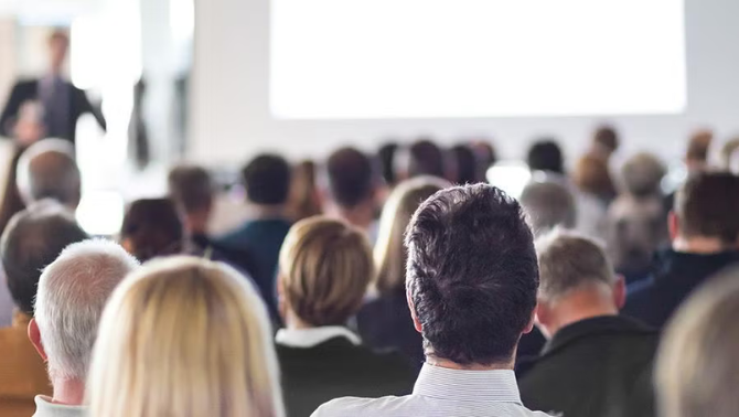 Conference attendees looking at the stage representing the Top Conferences to Grow Your Business