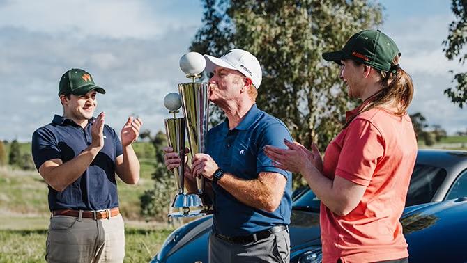 eople golfing on a course, showcasing the world golf competition and corporate golf events.