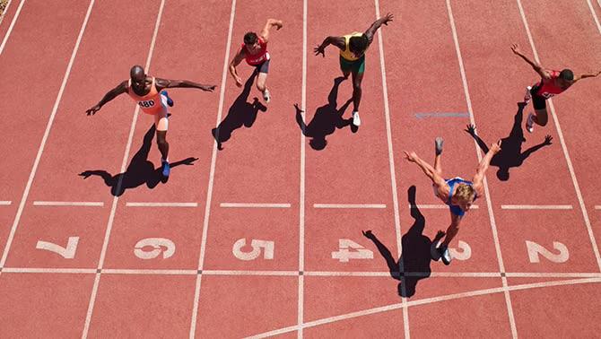 Athletes crossing a finish line, representing the Paris Olympics and the need for efficient corporate travel solutions.
