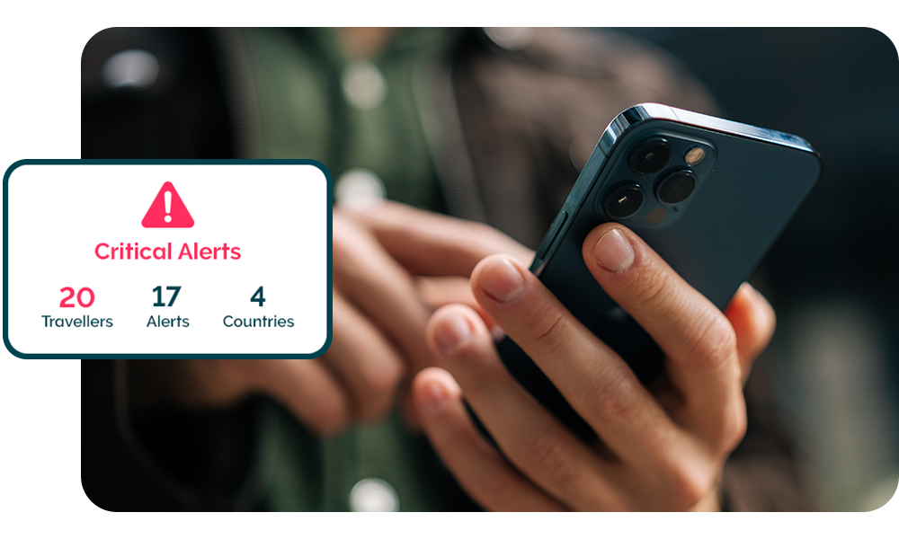 Hand holding a smartphone with text saying 'critical alerts' representing how travellers get an extra layer of traveller security with Safe & Secure. 