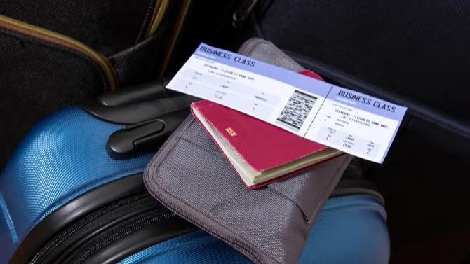 Airline tickets on a suitcase demonstrating Expert Tips for Improving Air Travel Programs.