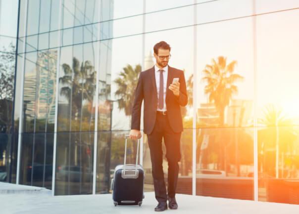 Business man walking with rolling bag