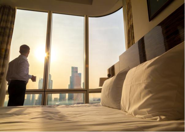 Man-in-Hotel-Room-At-Sunrise