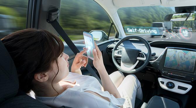 woman on phone self driving car 