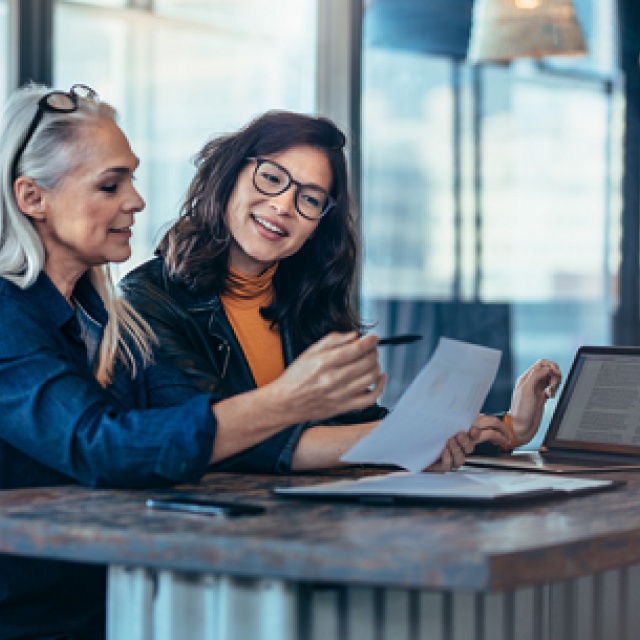 two ladies making notes